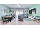 Bright living area with a large sectional sofa, ceiling fan, and access to an outdoor patio at 3191 Marshfield Preserve Way, Kissimmee, FL 34746