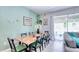 Spacious living and dining area with a large dining table and comfortable seating near sliding glass doors at 3191 Marshfield Preserve Way, Kissimmee, FL 34746