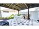 Covered patio with hexagon tile, dining table, and chairs at 3191 Marshfield Preserve Way, Kissimmee, FL 34746