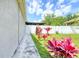 Side yard featuring white fence and landscaping at 3191 Marshfield Preserve Way, Kissimmee, FL 34746