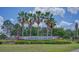 Signage at the Parkview at Lake Shore community with palm trees and landscaping at 3191 Marshfield Preserve Way, Kissimmee, FL 34746
