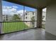 Spacious screened balcony with tile flooring and a tranquil view of the lush lawn at 3321 Whitestone Cir # 204, Kissimmee, FL 34741