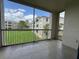 Spacious screened balcony with tile flooring and a tranquil view of the lush lawn at 3321 Whitestone Cir # 204, Kissimmee, FL 34741