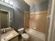 Bathroom features shower-tub combo, single sink vanity, and modern lighting at 3321 Whitestone Cir # 204, Kissimmee, FL 34741