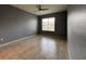 An empty bedroom featuring a window, ceiling fan, and neutral walls with tile flooring at 3321 Whitestone Cir # 204, Kissimmee, FL 34741