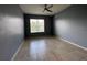An empty bedroom featuring a window, ceiling fan, and neutral walls with tile flooring at 3321 Whitestone Cir # 204, Kissimmee, FL 34741