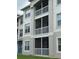 Exterior view of the building, with screened balconies and neutrally painted facade at 3321 Whitestone Cir # 204, Kissimmee, FL 34741