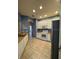 Bright kitchen features white cabinets, modern appliances, and ceramic tile flooring at 3321 Whitestone Cir # 204, Kissimmee, FL 34741