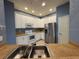 Bright kitchen features stainless steel appliances, white cabinets, and a double sink at 3321 Whitestone Cir # 204, Kissimmee, FL 34741