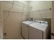 Laundry room features washer and dryer with wire shelving at 3321 Whitestone Cir # 204, Kissimmee, FL 34741