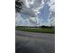 A scenic view of the pond, with a lush green lawn and water fountains at 3321 Whitestone Cir # 204, Kissimmee, FL 34741