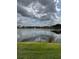 A scenic view of the pond on a sunny day at 3321 Whitestone Cir # 204, Kissimmee, FL 34741