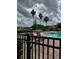 Community pool area with lounge chairs, lush landscaping, a spa and palm trees under a cloudy sky at 3321 Whitestone Cir # 204, Kissimmee, FL 34741