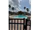 A large, inviting community pool is surrounded by lounge chairs and palm trees under a sunny sky at 3321 Whitestone Cir # 204, Kissimmee, FL 34741