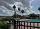 Community pool area with lounge chairs, lush landscaping, a spa and palm trees under a cloudy sky at 3321 Whitestone Cir # 204, Kissimmee, FL 34741