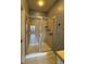 A tiled shower features a glass door, chrome fixtures, and built-in shelving at 3321 Whitestone Cir # 204, Kissimmee, FL 34741