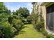 Spacious backyard with lush greenery and colorful landscaping, offering a peaceful and private retreat at 3535 Clay Brick Rd, Harmony, FL 34773