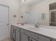 Bathroom features tile floors, neutral walls, glass shower door, and double sink vanity with modern fixtures at 3535 Clay Brick Rd, Harmony, FL 34773