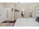 Cozy bedroom with wood floors, bright walls, walk-in closet, and view to a bathroom at 3535 Clay Brick Rd, Harmony, FL 34773