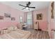 Charming bedroom featuring soft pink walls, a vanity area, and lots of natural light for a peaceful retreat at 3535 Clay Brick Rd, Harmony, FL 34773