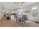 Bright dining area featuring a modern table set with natural lighting and a spacious kitchen in the background at 3535 Clay Brick Rd, Harmony, FL 34773