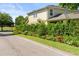 Charming home exterior with well-maintained landscaping, colorful flowers, and a view of the nearby lake at 3535 Clay Brick Rd, Harmony, FL 34773