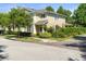 Inviting two-story home featuring neat landscaping on a corner lot with nearby trees at 3535 Clay Brick Rd, Harmony, FL 34773