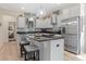 Modern kitchen features stainless steel appliances, granite countertops, stylish backsplash, and a large island with barstool seating at 3535 Clay Brick Rd, Harmony, FL 34773