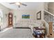 Spacious living room featuring elegant decor, cozy seating, and open staircase at 3535 Clay Brick Rd, Harmony, FL 34773