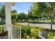 Scenic neighborhood view from front porch featuring pond and surrounding trees at 3535 Clay Brick Rd, Harmony, FL 34773