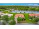 Aerial view of a single Gathering home with a terra cotta roof, a lake view, and mature trees at 4117 Navigator Way, Kissimmee, FL 34746