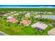 Beautiful aerial view of homes with tile roofs, green lawns, and mature trees, highlighting the neighborhood's charm at 4117 Navigator Way, Kissimmee, FL 34746