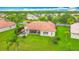 Aerial view of house with red tile roof, green lawn, patio and beautiful landscaping at 4117 Navigator Way, Kissimmee, FL 34746