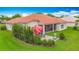 Aerial view of backyard showing lush lawn, manicured shrubs, patio, and red umbrella at 4117 Navigator Way, Kissimmee, FL 34746