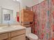 Cozy bathroom featuring a toilet, sink, mirror, and stylish shower curtain at 4117 Navigator Way, Kissimmee, FL 34746
