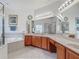 Bright and airy bathroom with double sink vanity, bathtub, and walk-in shower at 4117 Navigator Way, Kissimmee, FL 34746