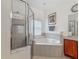 Clean bathroom featuring a tub, shower, and tile accents at 4117 Navigator Way, Kissimmee, FL 34746