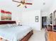 Bedroom suite featuring large bed, ceiling fan, and dresser with TV at 4117 Navigator Way, Kissimmee, FL 34746