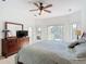 Bedroom with dresser, mirror and outdoor view with ceiling fan at 4117 Navigator Way, Kissimmee, FL 34746