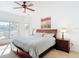 Bedroom suite featuring large bed, ceiling fan, and private view at 4117 Navigator Way, Kissimmee, FL 34746