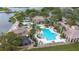 Expansive community pool with a water slide, surrounded by lush landscaping, offering residents a luxurious recreational experience at 4117 Navigator Way, Kissimmee, FL 34746