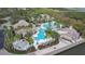 Aerial view of a luxury community pool area with palm trees and resort-style amenities, perfect for relaxation and recreation at 4117 Navigator Way, Kissimmee, FL 34746