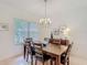 Formal dining room featuring a wooden table with seating for six and elegant chandelier at 4117 Navigator Way, Kissimmee, FL 34746