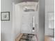 A bright and airy foyer with a white front door and a decorative overhead light fixture at 4117 Navigator Way, Kissimmee, FL 34746