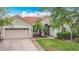 Charming single-Gathering home featuring a terra cotta roof, a brick driveway, and manicured landscaping at 4117 Navigator Way, Kissimmee, FL 34746