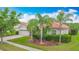 Single Gathering home featuring a terra cotta roof, lush landscaping, and a brick driveway at 4117 Navigator Way, Kissimmee, FL 34746