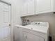 Laundry room featuring modern washer and dryer appliances with cabinets at 4117 Navigator Way, Kissimmee, FL 34746