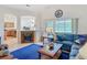 Inviting living room featuring a cozy fireplace, large windows with picturesque views, and stylish decor at 4117 Navigator Way, Kissimmee, FL 34746