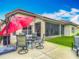 Outdoor patio with dining set, grill, and large red umbrella at 4117 Navigator Way, Kissimmee, FL 34746
