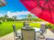 Outdoor patio with dining set, grill, large umbrella and view of lake at 4117 Navigator Way, Kissimmee, FL 34746